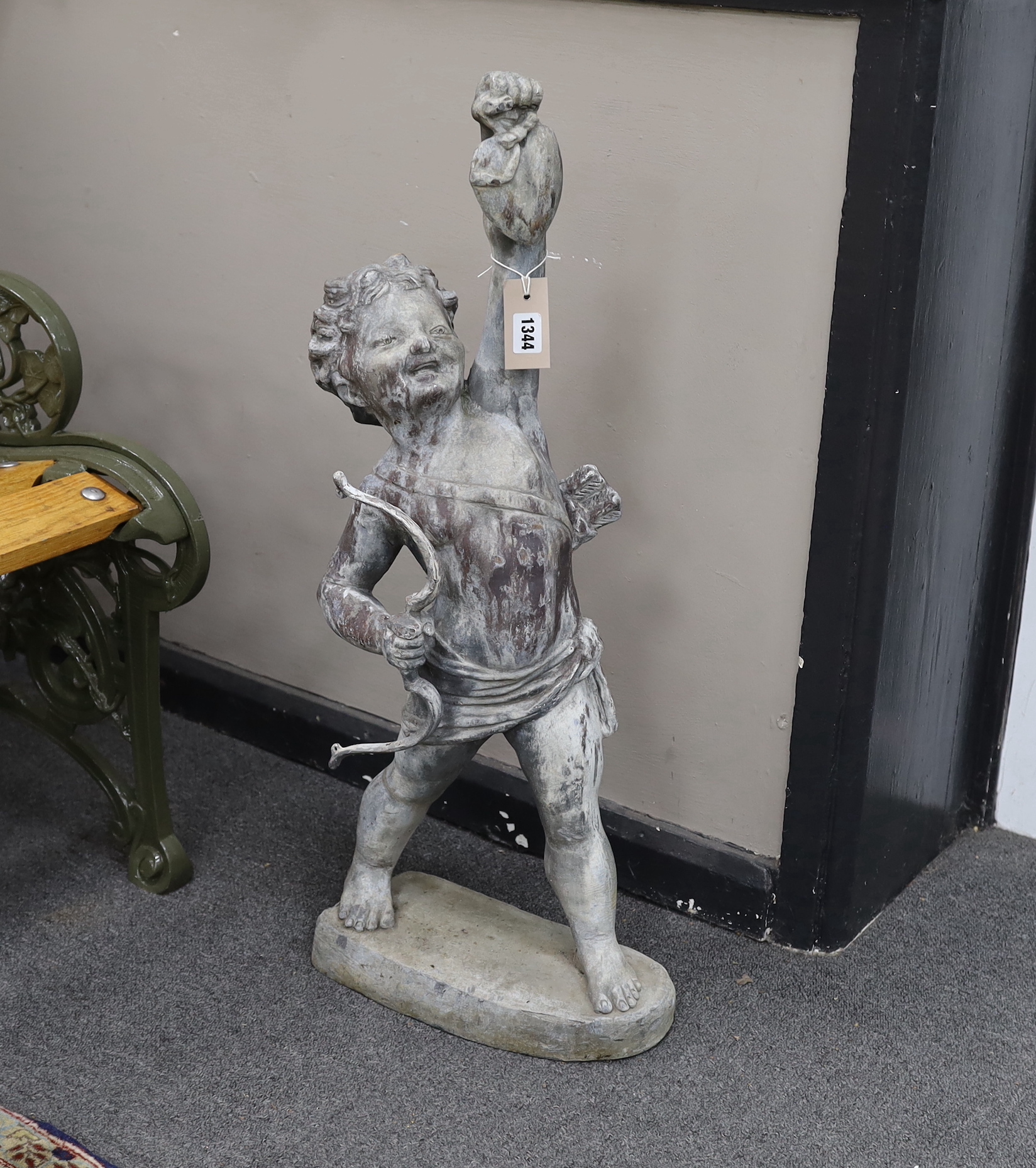 A Bromsgrove Guild lead garden ornament, “Love the Pedlar” with bow, height 80cm